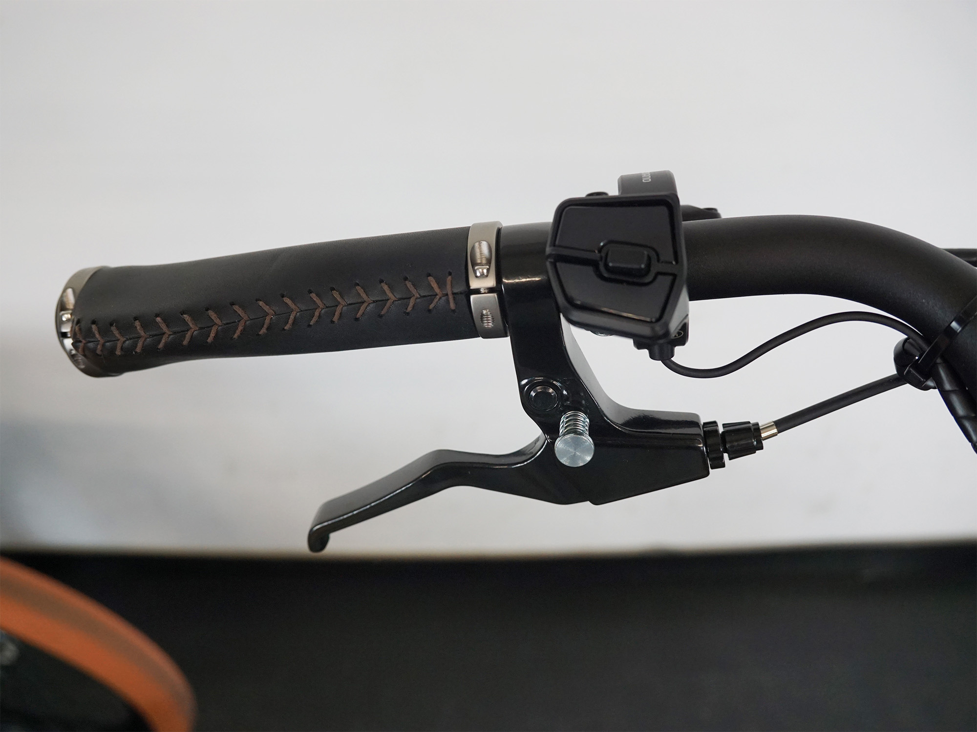 Ergonomischer Ledergriff mit Bedieneinheit und Bremshebel – komfortabel und funktional am Lenker.