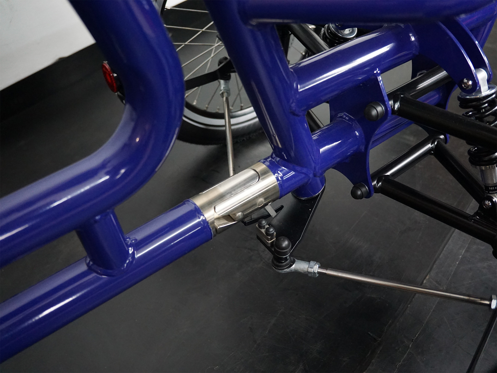 Nahaufnahme eines Gelenkverbinders mit Lenkgestänge an einem Therapierad – präzise Mechanik für Steuerungskopplung.